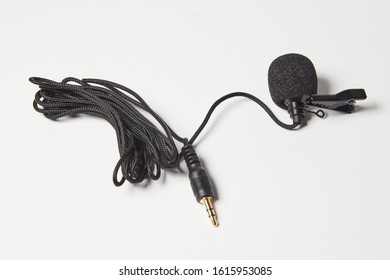 Small Lavalier Microphone Isolated On White Background. Professional Sound Recording Equipment. Lapel Mic. 