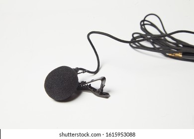 Small Lavalier Microphone Isolated On White Background. Professional Sound Recording Equipment. Lapel Mic. 