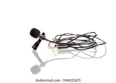 Small Lavalier Microphone Or Lapel Mic With Clip On White Background. Professional Sound Recording Equipment For Cell Phone.