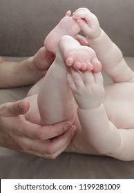 small legs in father's arms. newborn - Shutterstock ID 1199281009
