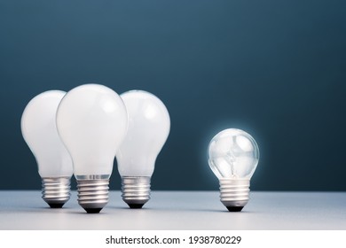 Small Light Bulb Has Own Light And More Brighter Than The Group Of Big Ones, Small Business In Competition Idea, Coaching Or Success Training Concept