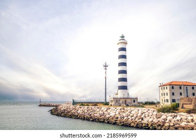 Small lighthouse in Lido de Jesolo in cloudy weather at the sea passage