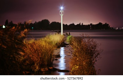 Small Lighthouse in the river at night