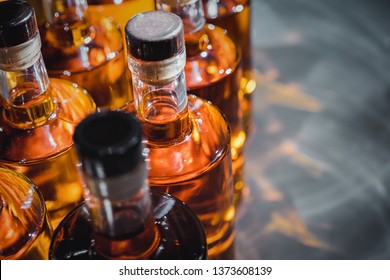 Small liquor production based on maple syrup. Multitude of pure alcohol bottles
 not labeled. Bottles placed in a row. - Powered by Shutterstock