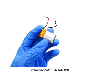 Small lithium polymer battery swollen in a hand on white background