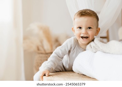 Small little caucasian toddler child kid son daughter smiling with first teeth, playing at home. Child care concept. Parenthood.