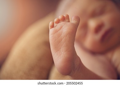 Small little feet of newborn baby
