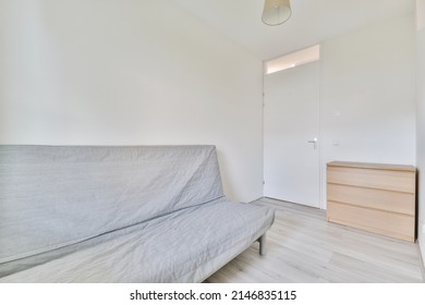 A Small Lounge Room With A Sofa On A Laminate Floors In A Modern House