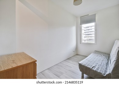 A Small Lounge Room With A Sofa On A Laminate Floors In A Modern House