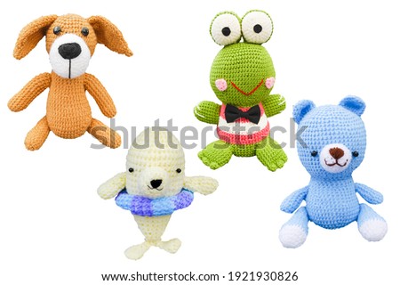 Small lovely toy blue bear ,brown dog, white dophine and green frog in crochet handmade on white background and clipping path .
