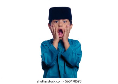 A Small Malay Boy Pose In Shock, Wearing A Baju Melayu And Songkok, A Traditional Malay Costume Isolated With White Background