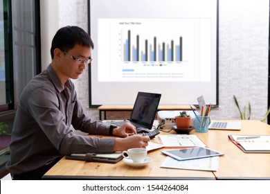 Small And Medium Enterprise Business Concept Of ,Businessman Using Calculator To Calculate Assets Chart