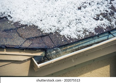 Small Melting Hail on the Roof. Severe Weather Concept.