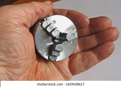 Small Metal Lathe 3-jaw Chuck On Hand Holding Close Up Macro.                               