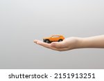 Small metal model toy car in child hand.