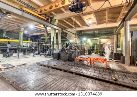 Small metal processing workshop. Sheet metal cutting plant. Pile of metal sheets piled in a stack.