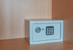A Small Metal Safe Inside A Cabinet With Password Buttons To Store Valuables. The Concept Is The Purchase Of A Cash Box.