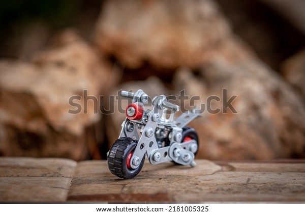 Small\
metal toy motorbike made from scrap metal\
parts.