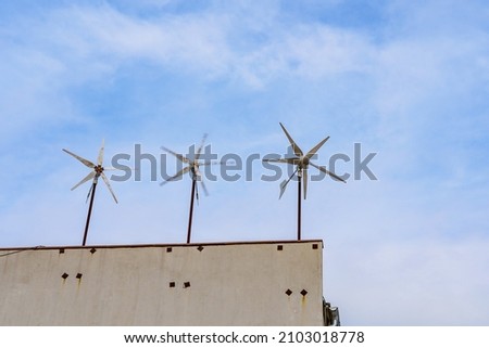 Small mini windmills for generating electricity in urban environments. Background with copy space