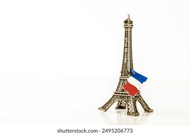 A small model of the Eiffel Tower with a red and white flag on top