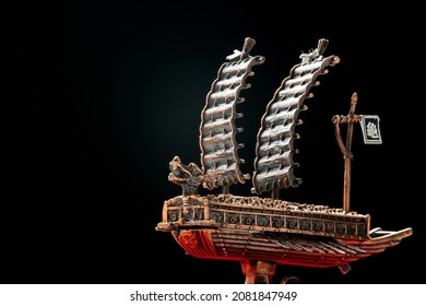 A Small Model Of Famous Ancient Korean Ironclad War Ship. Korean Turtle Ship On A Black Background.