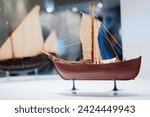 The small model of historical ancient ship in marine museum.