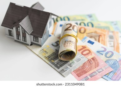 Small Model House on Layer of One Hundred Dollar Bills.