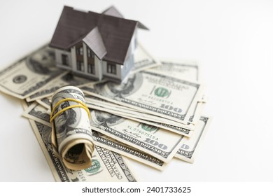Small Model House on Layer of One Hundred Dollar Bills.