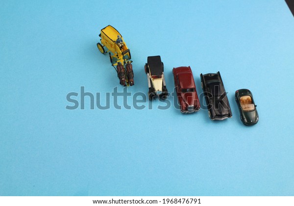 small models of cars showing the stages of technical\
progress 