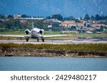 Small modern gray business jet taxiing for take off at Corfu Ioannis Kapodistrias international airport.