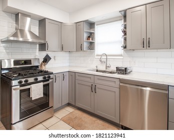 A Small Modern Kitchen With Grey Cabinets