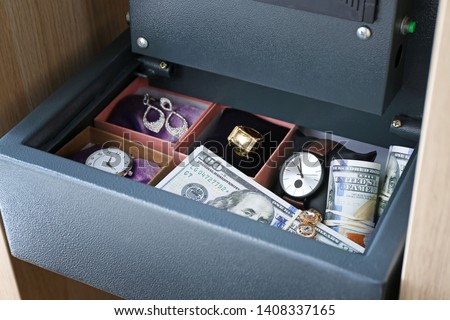 Small modern safe with valuables, closeup