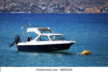 Small Motorboat Is Anchored On The Sea