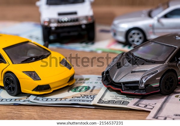 small motor-car\
with money euro and\
dollars
