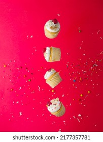 Small Mouth-watering Muffins With Cream And Fresh Raspberries On A Bright Pink Background With Colorful Confetti. There Are No People In The Photo. Advertising, Banner, Birthday Invitation.