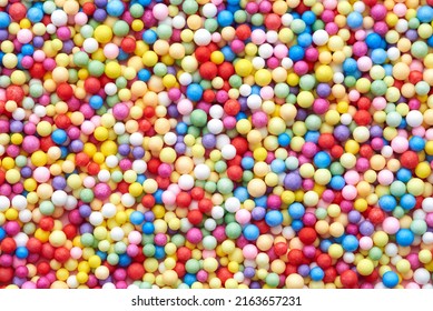 Small multicolored polyfoam balls, theme of holidays and birthdays, backdrop.