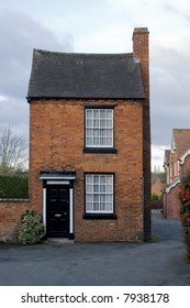 Small Narrow Brick Built House In Village Street