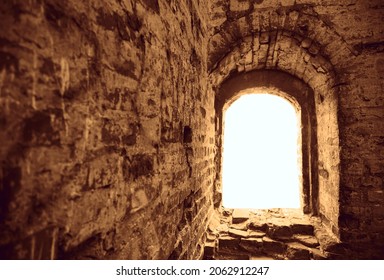 A Small Narrow Window On An Old, Ancient, Cracked Stone Shabby Brick Wall Of Red Brick In The Living Room. Architecture Background.