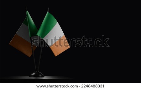 Small national flags of the Ireland on a black background.