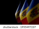 Small national flags of the Moldavia on a black background