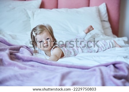 Similar – Little girl smiling lying over the bed