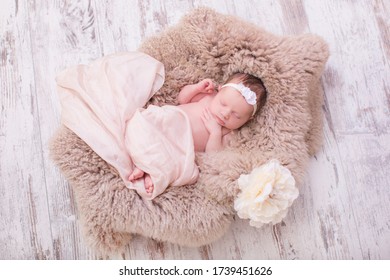 Small Newborn Cute Baby, Infant Girl Sleeping In A Basket In A Flower Dressing On A Rug In A Hat With A Toy, Tenderness Love Care, Angel Smile, Pastel Color In A Flower Dressing Bunny.