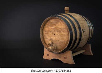 A Small, Oak Bourbon Barrel That Is Used To Age Bourbon Whiskey On A Black Background. Typically Corn Whiskey Is Used In The Barrels To Make Bourbon. Bourbon Making Is A Tradition In Southern US.