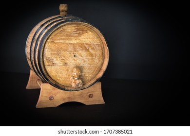 A Small, Oak Bourbon Barrel That Is Used To Age Bourbon Whiskey On A Black Background. Typically Corn Whiskey Is Used In The Barrels To Make Bourbon. Bourbon Making Is A Tradition In Southern US.