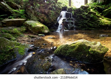 Small Oasis With Waterfall, Long Exposure Stream And Stone Lit By The Sun In The Foreground