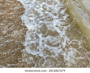 Small Ocean Waves Reaching Sandy Beach