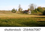 A small old barn on a farmers grassy field