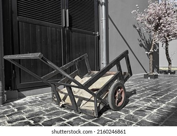 small old black cargo cart midday sunlight, emotional, sad despair, discouraged, concept, selective focus
