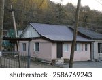 A small old house on the quiet street in the small town in the South of Russia in late-autumn