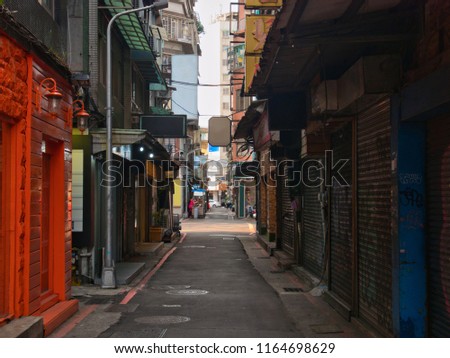 Small old Street in Taipei, Taiwan with garages, 
 shops and a red entrance and door